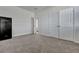 A well-lit bedroom featuring a large safe and carpeted floors, providing a secure and comfortable space at 308 Cypress Branch Rd, Huger, SC 29450