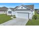 Charming single-Gathering home showcasing a spacious garage and well-maintained lawn at 308 Cypress Branch Rd, Huger, SC 29450