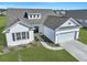 Charming single-story home features a manicured lawn, two-car garage, and classic white siding at 308 Cypress Branch Rd, Huger, SC 29450