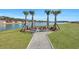 Fire pit overlooking a scenic lake with palm trees and chairs for community members to enjoy at 308 Cypress Branch Rd, Huger, SC 29450