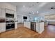Spacious open-plan kitchen with granite counters, stainless appliances, and hardwood floors at 308 Cypress Branch Rd, Huger, SC 29450