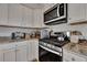 Kitchen with stainless appliances, granite countertops and wooden floors at 308 Cypress Branch Rd, Huger, SC 29450