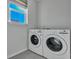 A modern laundry room equipped with an LG washer and dryer set under a bright window at 308 Cypress Branch Rd, Huger, SC 29450