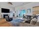 Comfortable living room area with a fireplace, television, and hardwood floors at 308 Cypress Branch Rd, Huger, SC 29450
