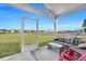 Inviting screened porch with outdoor furniture, offering a relaxing view of the green backyard at 308 Cypress Branch Rd, Huger, SC 29450