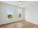 Sunlit bedroom with hardwood floors and large windows offering scenic outdoor views at 3107 S Shore Dr, Charleston, SC 29407