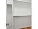 A walk-in closet with white shelves and racks and hardwood floors at 3107 S Shore Dr, Charleston, SC 29407