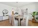 Bright dining room with a modern light fixture, stylish chairs, and open access to other spaces at 3107 S Shore Dr, Charleston, SC 29407