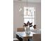 Charming dining area with a contemporary chandelier and serene natural light at 3107 S Shore Dr, Charleston, SC 29407
