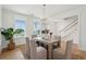 Well-lit dining room with a modern chandelier, natural light, and elegant decor at 3107 S Shore Dr, Charleston, SC 29407