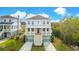 Inviting home with a striking red door, double garage, and dual front staircases at 3107 S Shore Dr, Charleston, SC 29407