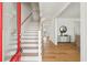 Elegant foyer with hardwood floors, white stairs, and a peek into the back porch at 3107 S Shore Dr, Charleston, SC 29407