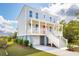 Inviting two-story home with a charming front porch, perfect for relaxing outdoors at 3107 S Shore Dr, Charleston, SC 29407