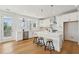 Bright kitchen with white cabinets, stainless steel appliances, pendant lighting, and hardwood floors at 3107 S Shore Dr, Charleston, SC 29407