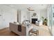 Bright and open living room featuring a ceiling fan, fireplace, and comfortable seating at 3107 S Shore Dr, Charleston, SC 29407