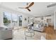 Open concept living room and kitchen featuring hardwood floors, modern furniture, and natural light at 3107 S Shore Dr, Charleston, SC 29407