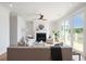 Bright living room with fireplace, ceiling fan, comfortable seating, and outdoor access at 3107 S Shore Dr, Charleston, SC 29407