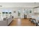 Bright and airy living room featuring wood floors, modern decor, and abundant natural light with adjoined open kitchen at 3107 S Shore Dr, Charleston, SC 29407