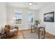 Bright office space with natural light from two windows, featuring a desk, chair, and comfortable armchair at 3107 S Shore Dr, Charleston, SC 29407