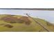 An aerial of a long pier walkway over a marsh leading to a covered gazebo at 3107 S Shore Dr, Charleston, SC 29407