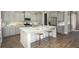 Beautiful kitchen features gray cabinets, stainless steel appliances, a white island, and hardwood floors, creating a modern feel at 320 Archar St, Summerville, SC 29486