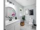 Modern bathroom with round mirror, black fixtures, white vanity, and decor at 3227 Stonehaven Dr, North Charleston, SC 29420