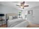 Bedroom featuring a ceiling fan, a bed with stylish pillows, and a view to the outside at 3227 Stonehaven Dr, North Charleston, SC 29420