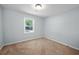 Bright bedroom with neutral carpet, light blue walls, and a window offering natural light at 3227 Stonehaven Dr, North Charleston, SC 29420