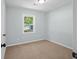 Bright bedroom with neutral carpet, light blue walls, and a window offering natural light at 3227 Stonehaven Dr, North Charleston, SC 29420