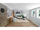 Comfortable living room with exposed brick, lots of light, and stylish decor at 3227 Stonehaven Dr, North Charleston, SC 29420