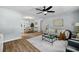 Open-concept living room featuring hardwood floors, a ceiling fan, and natural light at 3227 Stonehaven Dr, North Charleston, SC 29420