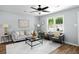 Cozy living room with large windows, hardwood floors, and stylish furnishings at 3227 Stonehaven Dr, North Charleston, SC 29420