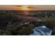 Aerial sunset view showing the roof and balconies of the beautiful two-story home and wooded landscape at 3547 Holmgren St, Mount Pleasant, SC 29466