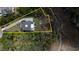 Aerial view of a property with defined boundaries, including mature landscaping, a driveway, and a two-story home at 3547 Holmgren St, Mount Pleasant, SC 29466
