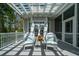 Lovely back porch with two chairs and a small table for relaxation under a trellis at 3547 Holmgren St, Mount Pleasant, SC 29466
