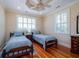 Bedroom with matching twin beds, hardwood floors, and a decorative ceiling fan at 3547 Holmgren St, Mount Pleasant, SC 29466