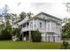 Rear exterior showcasing gray siding, a fenced yard, a screened in porch, and 3-car garage at 3547 Holmgren St, Mount Pleasant, SC 29466