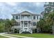Charming two-story home featuring a symmetrical facade, dual balconies, and a well-manicured lawn at 3547 Holmgren St, Mount Pleasant, SC 29466