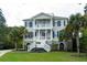 Charming two-story home featuring a symmetrical facade, dual balconies, and a well-manicured lawn at 3547 Holmgren St, Mount Pleasant, SC 29466
