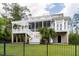 A backyard exterior shows a lawn, patio with pergola, porch, balcony, stairs, and black metal fence at 3547 Holmgren St, Mount Pleasant, SC 29466