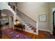 Elegant foyer featuring hardwood floors, a staircase with iron railings, and a decorative rug at 3547 Holmgren St, Mount Pleasant, SC 29466