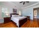 Well-lit bedroom featuring a large bed, hardwood floors, and a view into an adjoining bathroom at 3547 Holmgren St, Mount Pleasant, SC 29466