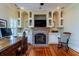 Office space with built-in shelves, a brick fireplace, and a desk at 3547 Holmgren St, Mount Pleasant, SC 29466