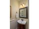 Traditional powder room featuring a dark wood vanity and a decorative mirror at 3547 Holmgren St, Mount Pleasant, SC 29466
