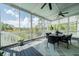 Relaxing screened porch with comfortable seating, ceiling fans, and serene outdoor views at 3547 Holmgren St, Mount Pleasant, SC 29466