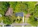Bird's-eye view of the home with a new roof and surrounded by mature trees at 405 Cross St, Charleston, SC 29407