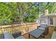 Inviting back deck featuring outdoor seating with a view of the spacious, tree-filled backyard at 405 Cross St, Charleston, SC 29407
