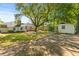 Spacious yard showcasing a shed for storage, surrounded by lush greenery and mature trees at 405 Cross St, Charleston, SC 29407