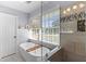 Stylish bathroom featuring a soaking tub, glass shower, and elegant fixtures at 405 Cross St, Charleston, SC 29407