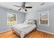 Bright bedroom with hardwood floors, ceiling fan, and two windows providing ample natural light at 405 Cross St, Charleston, SC 29407